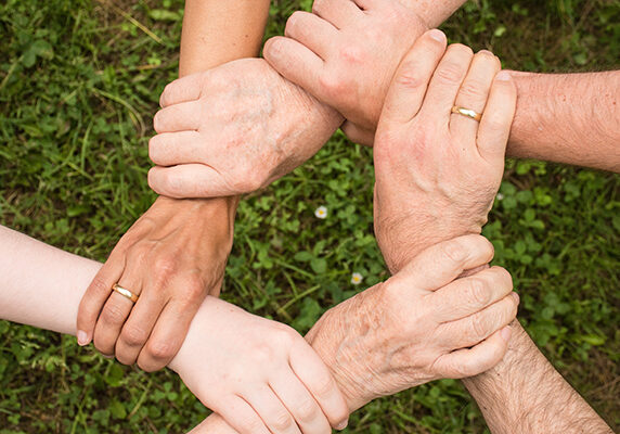 hands linking to form a circle